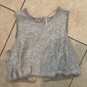 Silver and taupe cropped length top. Buttons down back and wide arm holes.